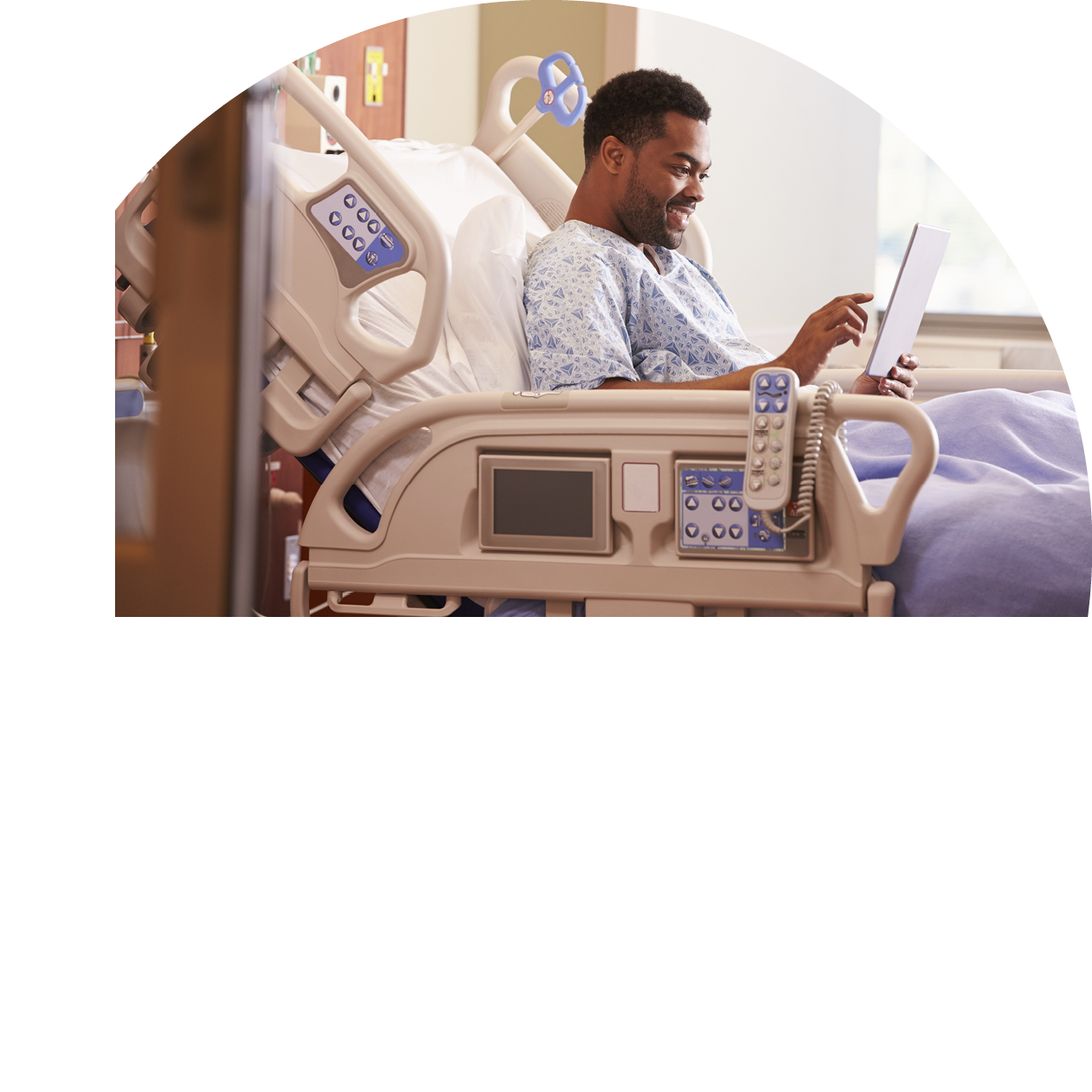 Male Patient In Hospital Bed Using Digital Tablet